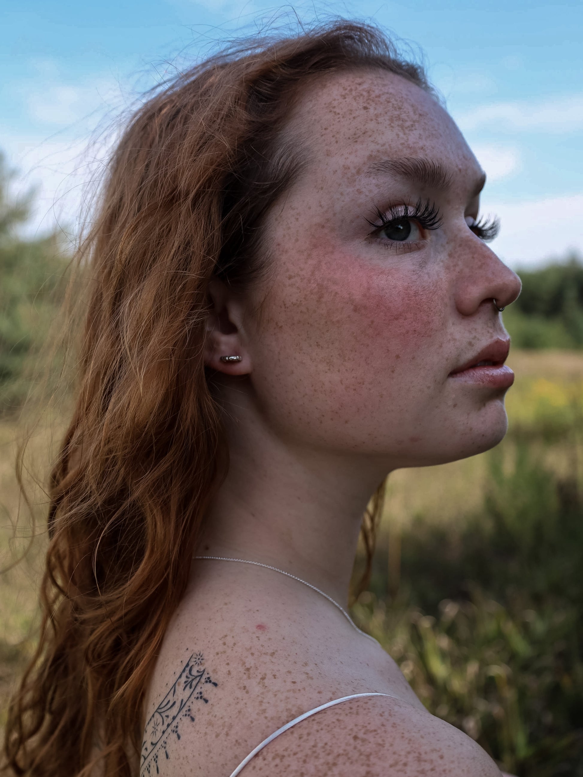 Sterling silSterling silver fungi stud earring, worn in a woman's ear. The stud stands out from the ear as if it is growing from it.