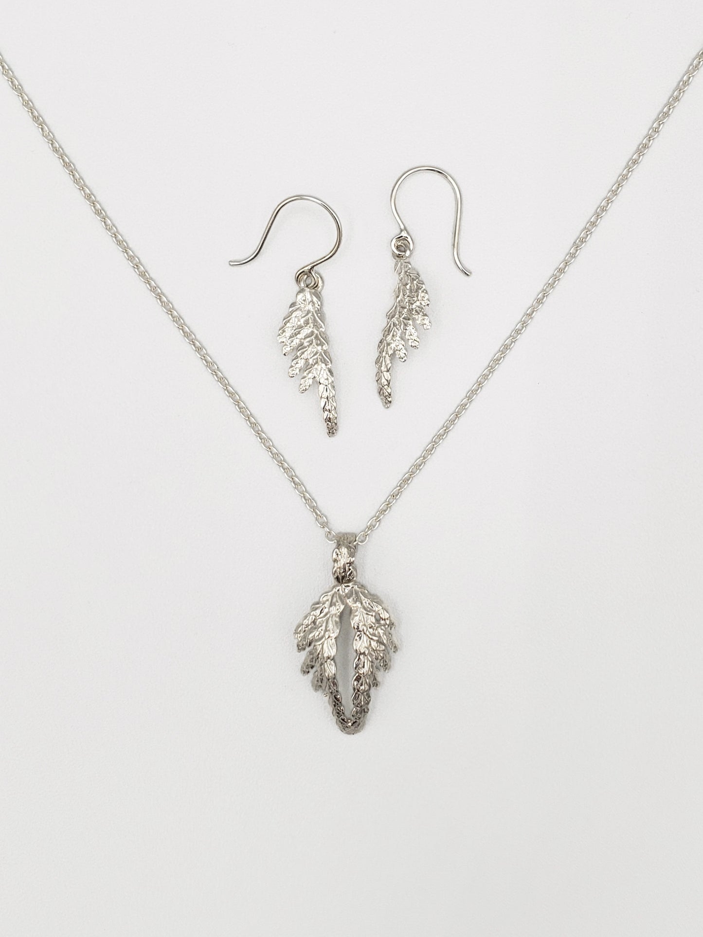 Sterling silver jewellery / jewelry set with cedar pendant resembling wings and cedar dangle earrings.