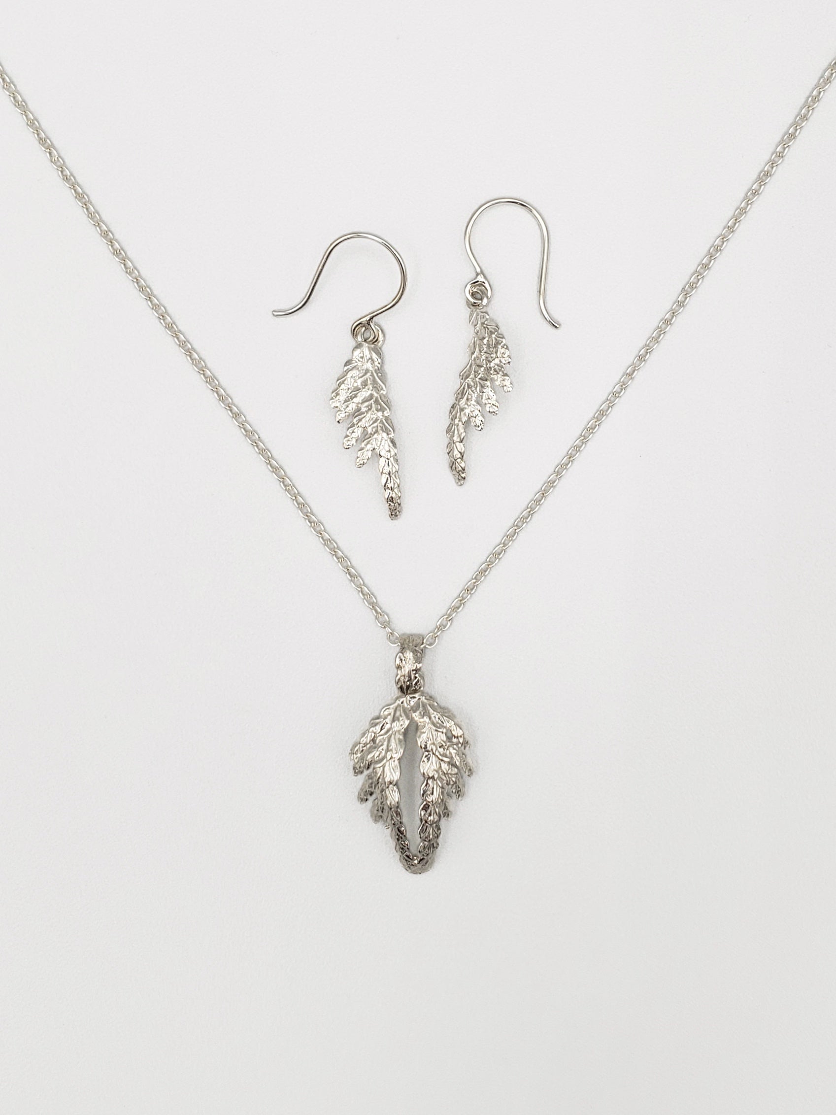 Sterling silver jewellery / jewelry set with cedar pendant resembling wings and cedar dangle earrings.