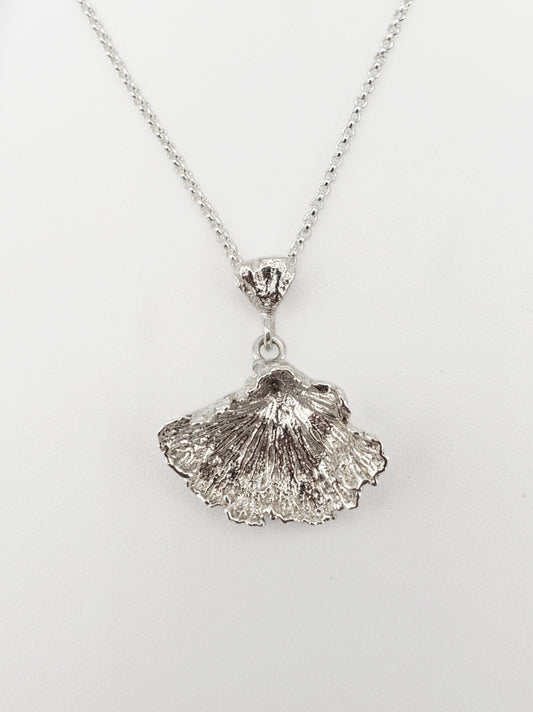 Sterling silver fungi pendant with ruffled edge.